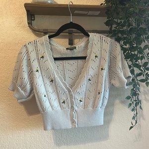 Baby blue button up sweater, yellow flower accents
